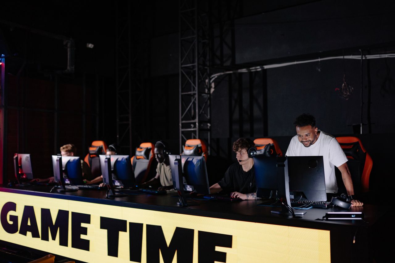 Esports team engaged in competitive gaming session indoors, showcasing teamwork and concentration.